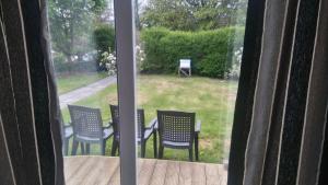 a view of a table and chairs from a window at Murrevagh Mealog in Tooreen