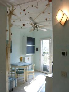 a kitchen with a table and a ceiling fan at Casa Blu in Imperia