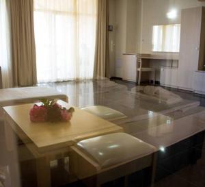 a kitchen with a table with a plate of fruit on it at Apart Hotel Apolonia Palace in Sinemorets