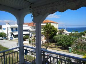 a view of the ocean from the porch of a house at Grigorios Apartments in Nea Vrasna