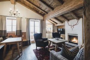 a living room with a couch and a fireplace at Himmlhof in Sankt Anton am Arlberg