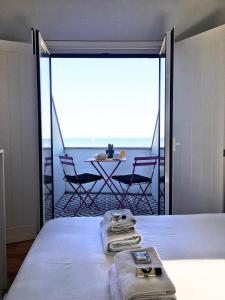 a bedroom with a bed with a view of the ocean at Casa da Maria Alfama in Lisbon
