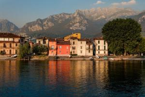 a group of buildings next to a body of water at Casa del Cedro - Cedar House in Lecco