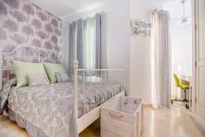 a bedroom with a bed with a white bed frame at Bungalow el Valle in Puerto Rico with Jacuzzi in Puerto Rico de Gran Canaria +21 photos