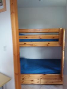 a wooden bunk bed in a room at STUDIO entre ciel et Lac in Thollon