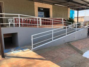a balcony with a white railing on a building at Epílogo Palace Hotel in Rio Branco