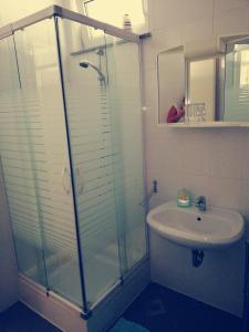 a bathroom with a glass shower and a sink at Apartment Lent in Maribor