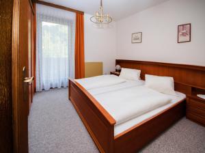 a bedroom with a bed and a window at Haus Egger in Oberdrauburg