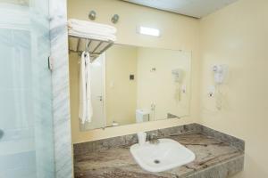 a bathroom with a sink and a toilet at Makai Resort All Inclusive Convention Aracaju in Aracaju