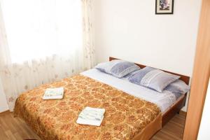 a bedroom with a bed with two towels on it at Evita Hotel in Dolinka