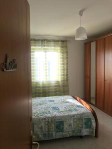 A bed or beds in a room at B&B Tra gli ulivi