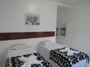 Säng eller sängar i ett rum på Pousada katyara