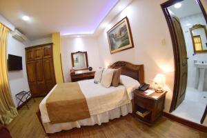 Ένα ή περισσότερα κρεβάτια σε δωμάτιο στο El Gran Hotel de Pereira