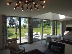 a living room with a chandelier and a table and chairs at Stern am Kap 2 in Putgarten
