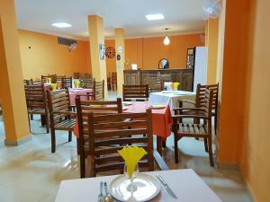 a dining room with tables and chairs in a restaurant at Select Hôtel in Morondava