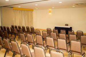 a conference room with chairs and a podium at Gandini Hotel in Itu