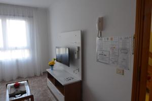 a kitchen with a refrigerator and a table and a window at Armonía Beach 17 in Arinaga