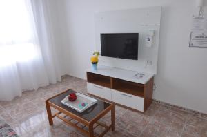 a living room with a tv and a coffee table at Armonía Beach 17 in Arinaga