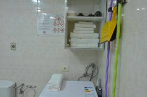 a bathroom with a sink and a pile of towels at Armonía Beach 17 in Arinaga