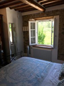 a bedroom with a bed and a window at casamariu in Lucca