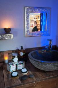 a bathroom with a tub and a person in a mirror at Logis Hôtel et Spa Le Christiania in La Salle-les-Alpes +37 photos