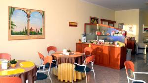a restaurant with tables and chairs in a room at Hotel Sabo' in Castel Maggiore