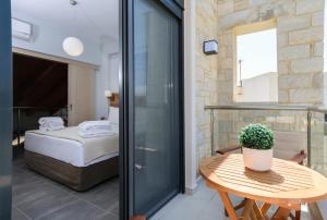 a room with a bed and a table with a potted plant at Villa Thalia in Stalos +71 photos