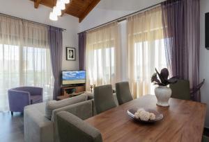 a living room with a dining room table and a couch at Villa Thalia in Stalos