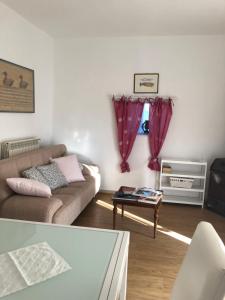 a living room with a couch and a table at Maremma Toscana Podere Poggiarelli in Campagnatico