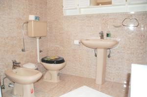 a bathroom with a toilet and a sink at Spacious Apartment in quiet surrounding in Ičići