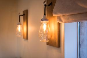 three lights hanging on a wall next to a window at La Vie en Rose - a fully equipped pet friendly contactless house with fenced garden between the fields in Torhout