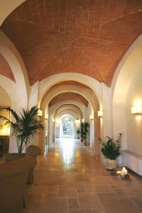 a large room with a walkway leading to a stairway at Hotel Certaldo in Certaldo