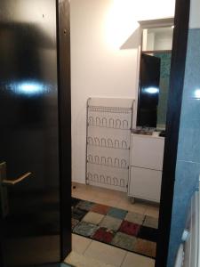 a bathroom with a black refrigerator and a television at Apartment Terra in Mali Lošinj