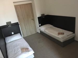 Postel nebo postele na pokoji v ubytování Hotel Jordánek