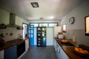 a kitchen with a refrigerator and a table with oranges on the counter at Casa Candelas in Lugo de Llanera