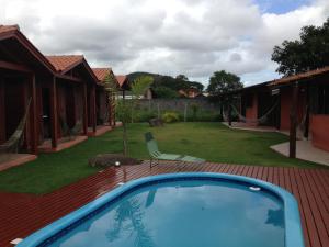 a swimming pool on a deck with a yard at Green Mountain Pousada in Florianópolis