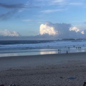 a group of people walking on the beach at Green Mountain Pousada in Florianópolis
