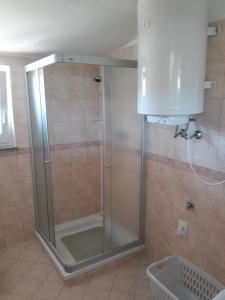 a shower with a glass door in a bathroom at House Barizoni in Ankaran