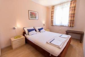 a bedroom with a large bed with blue pillows at Apartment Paulina in Cres