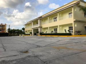 a large apartment building with a large parking lot at Hotel Yonu in Punta Cana