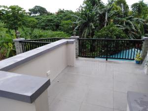 a balcony with a black fence and a tile floor at Diaz Residence in Silang