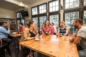 a group of people sitting around a wooden table in a restaurant at HI San Francisco Fisherman's Wharf Hostel in San Francisco +37 photos