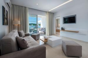 a living room with a couch and a tv at Gaia Palace in Mastihari