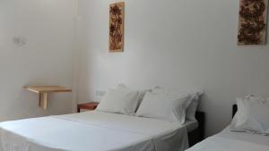 Postel nebo postele na pokoji v ubytování Nungwi House