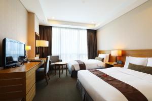 Postel nebo postele na pokoji v ubytování Bridge Hotel Incheon Songdo