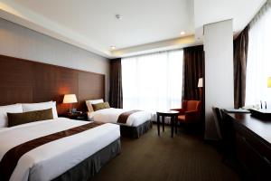 Säng eller sängar i ett rum på Bridge Hotel Incheon Songdo