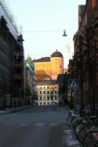 a city street with a building in the background with bikes parked at Hotell Centralstation in Uppsala
