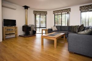 a living room with a couch and a coffee table at Margaret River Hideaway & Farmstay in Margaret River Town