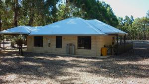 a small house with a blue roof at Margaret River Hideaway & Farmstay in Margaret River Town