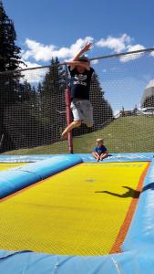 a boy jumping off of a trampoline on a trampoline at Haus Alpenpanorama in Fendels +27 photos